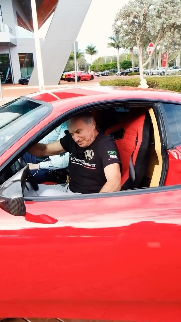 Luciano Sansalone at the wheel of a red Ferrari