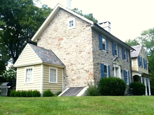 Bucks County fieldstone farmhouse after stucco removal and repointing