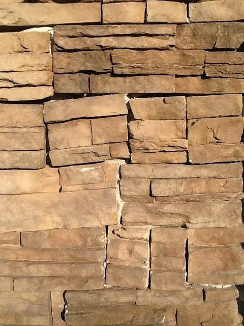 Veneer stone set by a previous contractor with wide, uneven joints